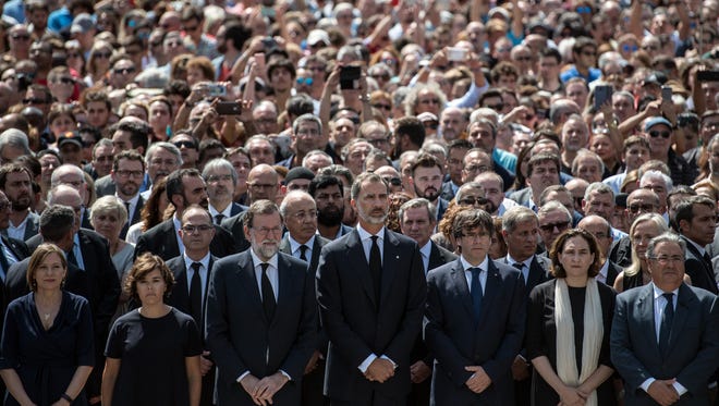 King Felipe VI of Spain (C) and Spanish Prime Minister Mariano Rajoy (C-L) join other dignitaries and residents of Barcelona in Placa de Catalunya to observe one minute of silence for the victims of the terrorist attack, on Aug. 18, 2017 in Barcelona, Spain.