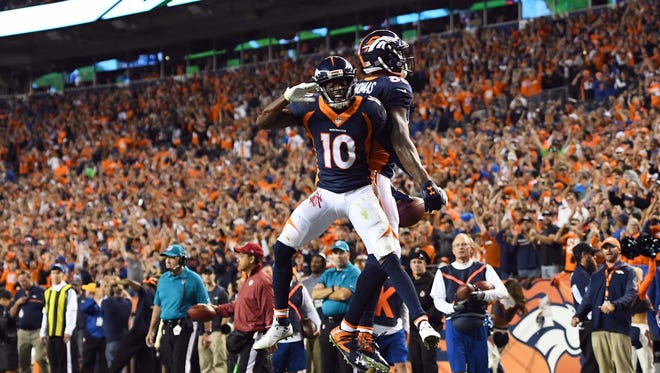Broncos receiver Demaryius Thomas (88) celebrates his first-half touchdown catch with Emmanuel Sanders (10).