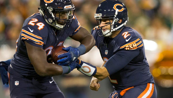 Chicago Bears quarterback Brian Hoyer (2) hands the football off to running back Jordan Howard (24) during the first quarter against the Green Bay Packers at Lambeau Field.