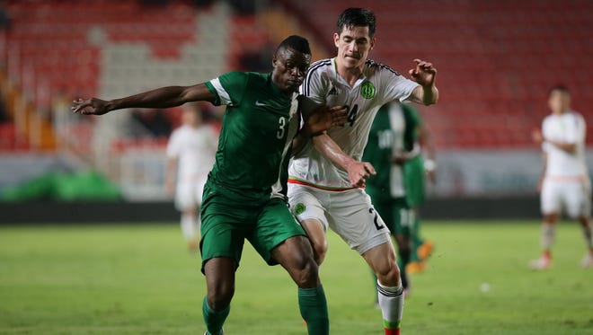Nigeria's Stanley Amuzie, left, in action against Mexico.