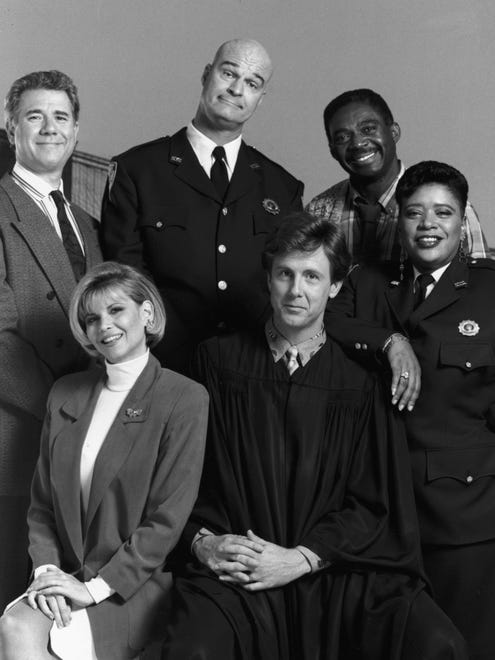 Assistant District Attorney Dan Fielding (John Larroquette, top left) and public defender Christine Sullivan (Markie Post, bottom left) were joined by Bull Shannon (Rochard Moll, clockwise from Larroquette), Mac Robinson (Charles Robinson) Roz Russell (Marsha Warfield) and Judge Harry T. Stone (Harry Anderson),  on NBC courtroom comedy 'Night Court.'