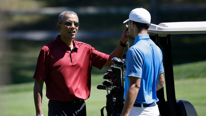 2015: President Barack Obama speaks with Stephen Curry while golfing.