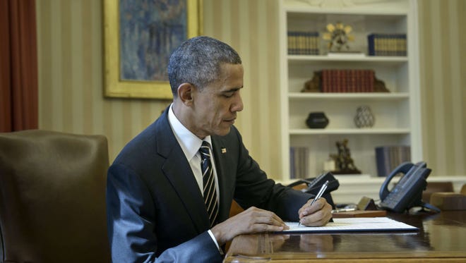 President Obama signs the executive order.