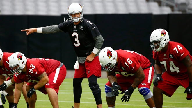 Arizona Cardinals quarterback Carson Palmer (3) signals at the line of scrimmage during the opening day of training camp at University of Phoenix Stadium.