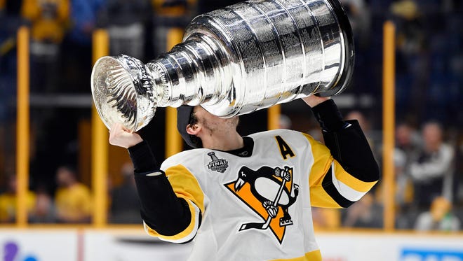Jun 11, 2017; Nashville, TN, USA; Pittsburgh Penguins center Evgeni Malkin (71) kisses the Stanley Cup after defeating the Nashville Predators in game six of the 2017 Stanley Cup Final at Bridgestone Arena.  Mandatory Credit: Christopher Hanewinckel-USA TODAY Sports