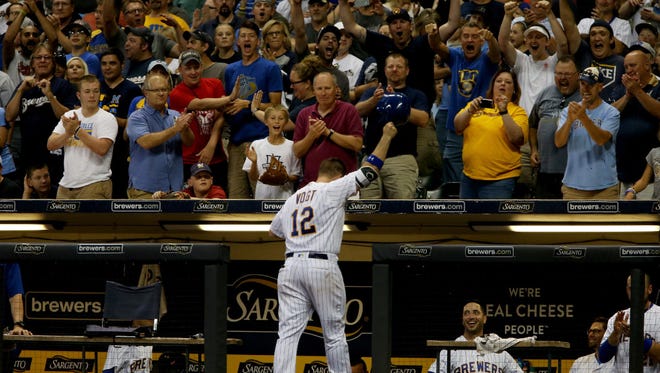 Stephen Vogt takes a curtain call after his two-run homer in the seventh inning against the Marlins on Friday night at Miller Park.
