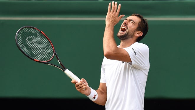 Marin Cilic reacts as he plays Roger Federer.
