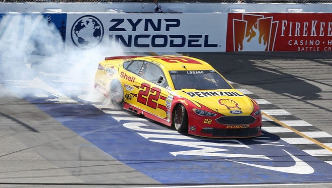 Joey Logano does a burnout after winning the Sprint Cup Series race at Michigan International Speedway on June 12.