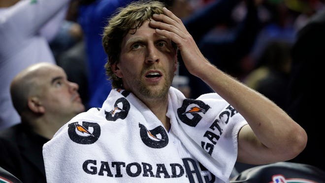 Dallas Mavericks Dirk Nowitzki rests on the bench during half-time at a regular-season NBA basketball game with the Phoenix Suns in Mexico City, Thursday, Jan. 12, 2017.