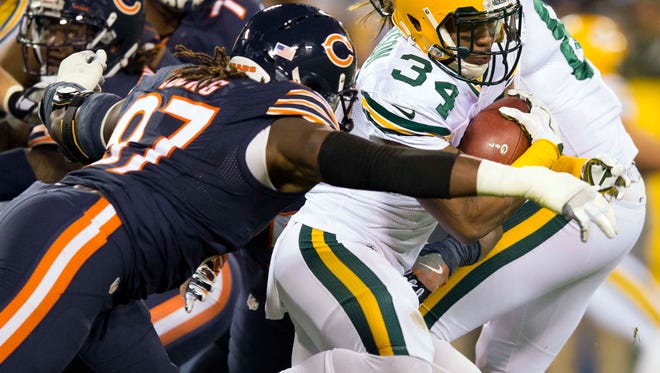 Green Bay Packers running back Knile Davis (34) is tackled by Chicago Bears linebacker Willie Young (97) during the second quarter at Lambeau Field.