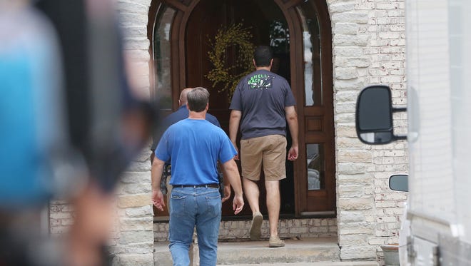 Subway restaurant spokesman Jared Fogle walks into his home with Federal authorities, Tuesday, July 7, 2015, in Zionsville, Ind. FBI agents and Indiana State Police have removed electronics from the property. FBI Special agent Wendy Osborne said the FBI was conducting an investigation in Zionsville, an affluent Indianapolis suburb, area but wouldn't say whether it involved Fogle or describe the nature of the investigation.