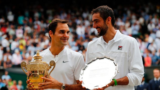 Switzerland's Roger Federer (left) and Croatia's Marin Cilic (right) pose with their trophies.