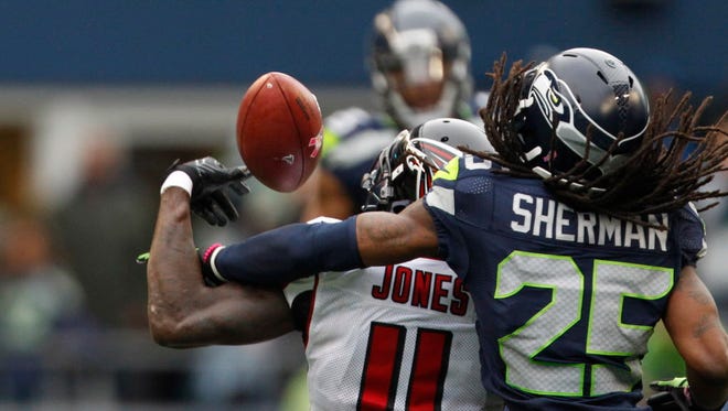 Seahawks cornerback Richard Sherman (25) defends a pass intended for Falcons wide receiver Julio Jones (11) during the fourth quarter.