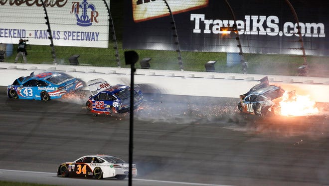 Landon Cassill (34) avoids Aric Almirola (43), Joey Logano (22) and Danica Patrick (10) during the Monster Energy NASCAR Cup Series Go Bowling 400 at Kansas Speedway on May 13, 2017 in Kansas City, Kan.