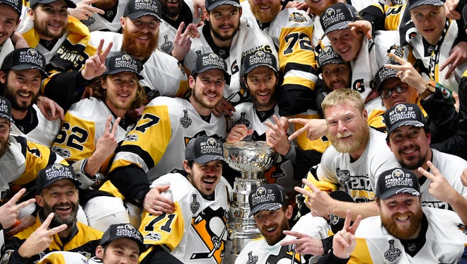 Pittsburgh Penguins players pose for a team photo with the Stanley Cup after defeating the Nashville Predators in Game 6.
