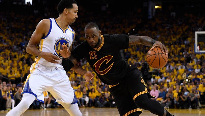 Cleveland Cavaliers forward LeBron James (23) drives to the basket against Golden State Warriors guard Shaun Livingston (34) during the first half in game two of the 2017 NBA Finals at Oracle Arena.