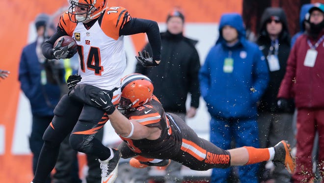Cincinnati Bengals quarterback Andy Dalton (14) is tackled from behind on a quarterback scramble in the fourth quarter during the Week 14 NFL game between the Cincinnati Bengals and the Cleveland Browns, Sunday, Dec. 11, 2016, at FirstEnergy Stadium in Cleveland. Cincinnati won 23-10.