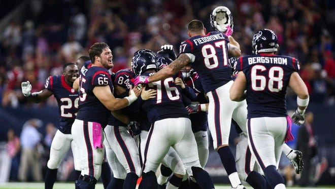 Texans players celebrate after defeating the Colts in overtime.