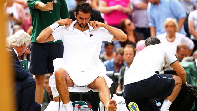 Marin Cilic is given treatment during the match.