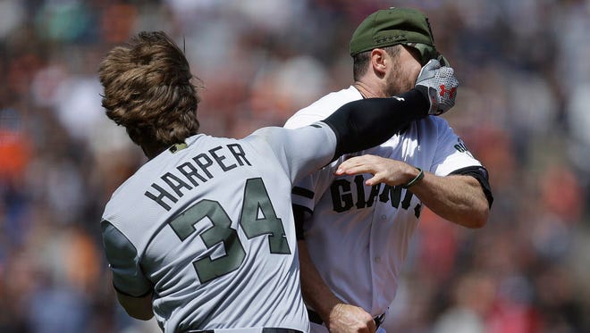 Washington Nationals' Bryce Harper (34) hits San Francisco Giants' Hunter Strickland in the face after being hit with a pitch in the eighth inning of a baseball game Monday, May 29, 2017, in San Francisco. (AP Photo/Ben Margot) ORG XMIT: CABM109