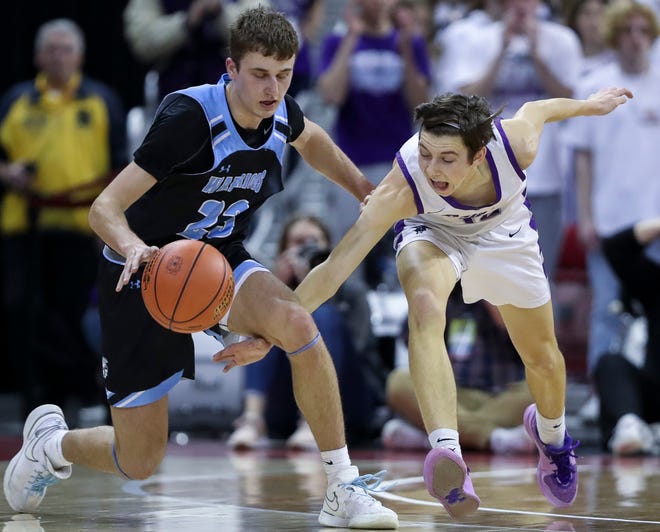 Kiel High School's Aidan Murphy (12) nearly steals the ball from Lakeside Lutheran High School's Alex Reinke (23) in a Division 3 quarterfinal game during the WIAA state boys basketball tournament on Thursday, March 14, 2024 at the Kohl Center in Madison, Wis. Lakeside Lutheran won the game, 57-55.