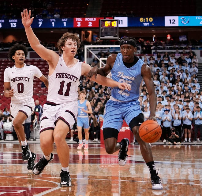 Prescott's Mason Schommer (11) attempts to guard St. Thomas More's Sekou Konneh (25) during the first half of the WIAA Division 3 boys basketball state semifinal game on Thursday March 14, 2024 at the Kohl Center in Madison, Wis.