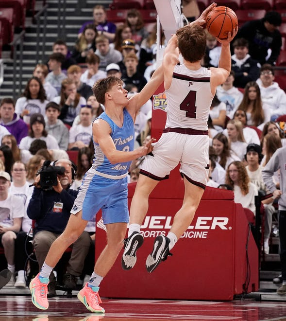 St. Thomas More's Evan Oleson (2) attempts to block Prescott's Barrett Temmers (4) during the second half of the WIAA Division 3 boys basketball state semifinal game on Thursday March 14, 2024 at the Kohl Center in Madison, Wis.