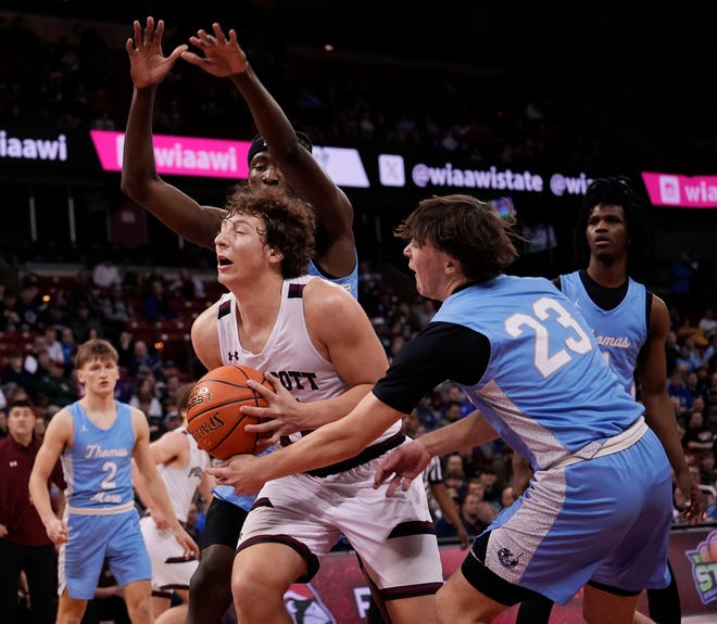 Prescott's Mason Schommer (11) attempts to drive the ball up the court as he is guarded by St. Thomas More's Brayden Alivo (23) during the second half of the WIAA Division 3 boys basketball state semifinal game on Thursday March 14, 2024 at the Kohl Center in Madison, Wis.