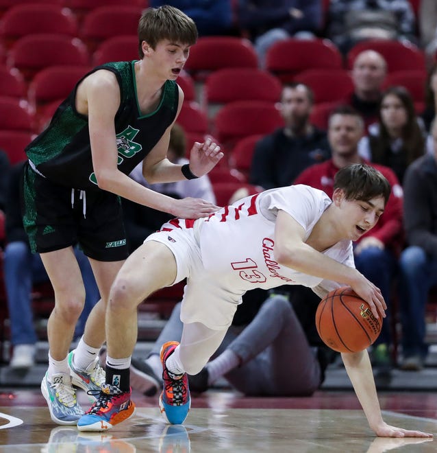 Abundant Life Christian School's Conner Whitaker (13) travels as he falls to the floor while Almond-Bancroft High School's TJ Lamb (5) pressures the ball in a Division 5 semifinal game during the WIAA state boys basketball tournament on Friday, March 15, 2024 at the Kohl Center in Madison, Wis. Abundant Life Christian won the game, 42-37.