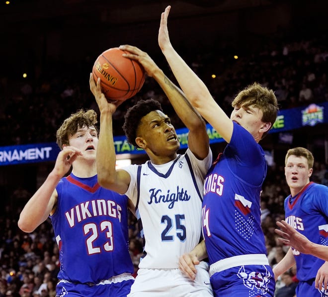 Nicolet's Davion Hannah (25) is guarded by Wisconsin Lutheran's Trey Raabe (14) and Zavier Zens (23) during the first half of the WIAA Division 2 boys basketball state semifinal game on Friday March 15, 2024 at the Kohl Center in Madison, Wis.