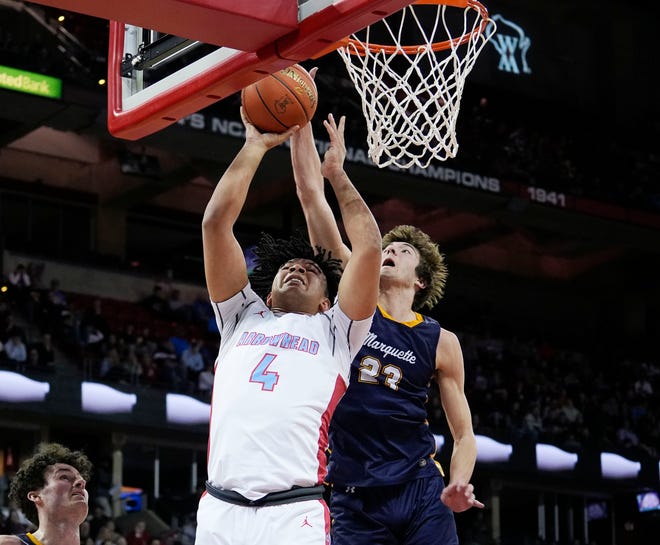 Marquette's Nolan Minessale (23) blocks the shot from Arrowhead's Jace Gilbert (4) during the first half of the WIAA Division 1 boys basketball state championship game on Saturday March 16, 2024 at the Kohl Center in Madison, Wis.