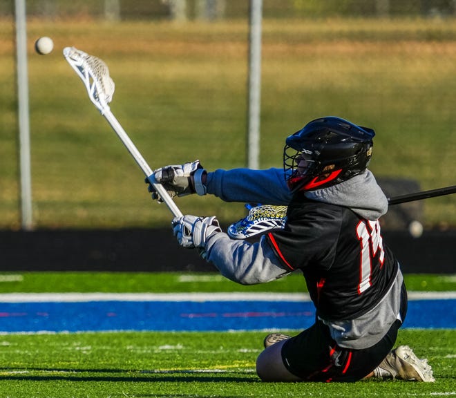 Cedarburg's Connor Plunk (14) takes a shot on goal during the lacrosse match at Catholic Memorial on Wednesday, March 20, 2024. Cedarburg won 6-5.