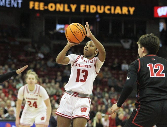 Wisconsin's Ronnie Porter (13) pulls up for jump shot during a WNIT game at the Kohl Center in Madison, Wisconsin on Thursday March 28, 2024.