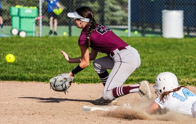 Brookfield Central's Maggie Feng (14) slides in for a double as Menomonee Falls second baseman Sam Goss (23) waits on the throw in the game at Brookfield Central, Monday, April 15, 2024.