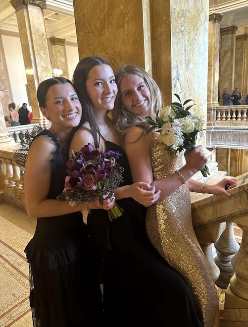 Sussex Hamilton High School students (from left) Florence Maas, Aviya Mitchell and Liv Frea pose for a prom photo on Saturday, April 20, 2024, at the Milwaukee Public Library before heading to the dance at the Chandelier Ballroom in Hartford.