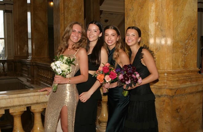 A group of Sussex Hamilton students (from left) Liv Frea, Aviya Mitchell, Elise Damato and Florence Maas pose for a prom photo at the Milwaukee Public Library before heading to the dance on Saturday, April 20, at the Chandelier Ballroom in Hartford.