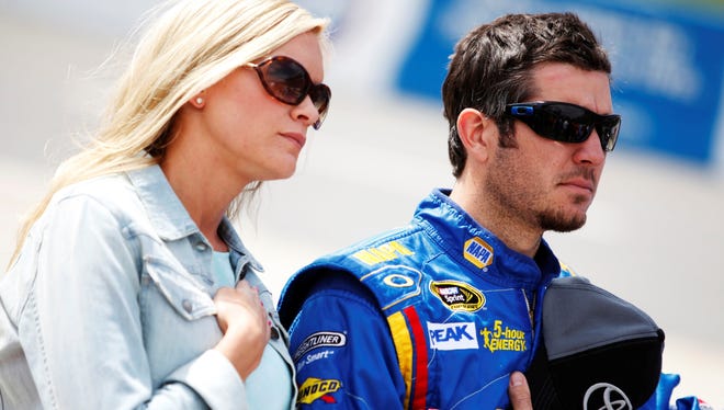 Martin Truex Jr. stands with girlfriend, Sherry Pollex, during prerace ceremonies for the NASCAR Sprint Cup Series STP Gas Booster 500 on April 7, 2013 at Martinsville Speedway in Ridgeway, Virginia.