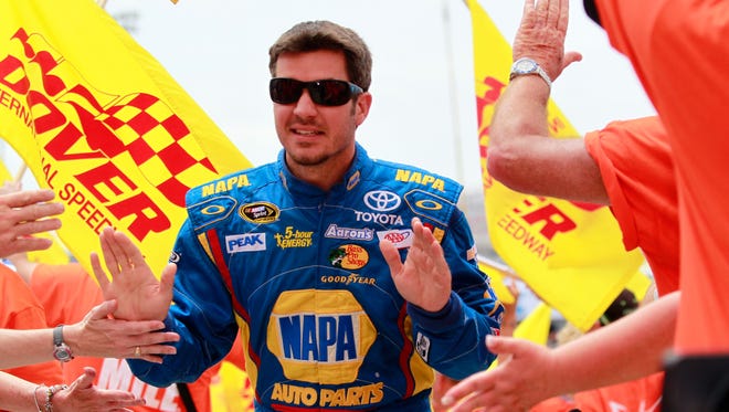 Martin Truex Jr., driver of the #56 NAPA Auto Parts Toyota, takes part in pre-race ceremonies for the NASCAR Sprint Cup Series FedEx 400 benefiting Autism Speaks at Dover International Speedway on June 2, 2013 in Dover, Delaware.