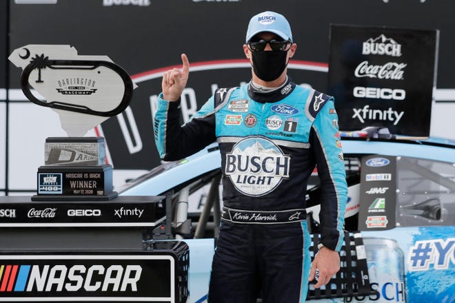 A masked Kevin Harvick celebrates in a empty victory lane after winning the Real Heroes 400 at Darlington Raceway on May 17 in NASCAR's first race back after a 10-week shutdown because of the coronavirus.